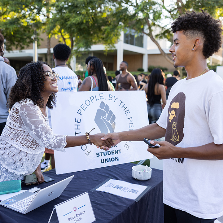 Two students shaking hands